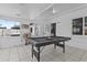 Spacious game room featuring a black pool table, ample lighting, and neutral decor creating a fun, social area at 829 W Mitchell Dr, Phoenix, AZ 85013