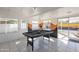 Spacious game room with pool table, tile floor, mural, and natural light from sliding glass doors at 829 W Mitchell Dr, Phoenix, AZ 85013