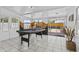 Bright game room with a pool table, natural light from multiple windows, and easy access to the outdoor area at 829 W Mitchell Dr, Phoenix, AZ 85013