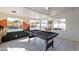 Bright game room with black pool table and desert mural, flooded with sunlight from sliding glass doors at 829 W Mitchell Dr, Phoenix, AZ 85013