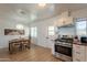Bright kitchen area with a dining table, stainless steel oven and white cabinetry at 829 W Mitchell Dr, Phoenix, AZ 85013