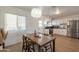 Open kitchen featuring white cabinets, stainless steel appliances, and an adjacent dining area at 829 W Mitchell Dr, Phoenix, AZ 85013