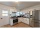 Well-lit kitchen with stainless steel appliances, white cabinetry and wood countertops at 829 W Mitchell Dr, Phoenix, AZ 85013