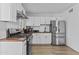 Modern kitchen with stainless steel appliances, white cabinets, wood countertops, and tiled backsplash for a sleek design at 829 W Mitchell Dr, Phoenix, AZ 85013
