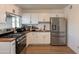Modern kitchen showcasing stainless steel appliances, wood countertops, and stylish white cabinets at 829 W Mitchell Dr, Phoenix, AZ 85013