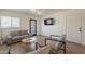 Modern living room featuring hardwood floors, a neutral-toned sofa, and ample space for seating at 829 W Mitchell Dr, Phoenix, AZ 85013