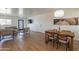 Open-concept living area with hardwood floors, a dining table, and seamless flow into the dining area at 829 W Mitchell Dr, Phoenix, AZ 85013