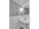 Bathroom view showcasing a pedestal sink and a mirror at 8522 E Montebello Ave, Scottsdale, AZ 85250