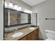 Bright bathroom featuring a double sink vanity, a large mirror, and a toilet at 8522 E Montebello Ave, Scottsdale, AZ 85250