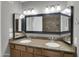 Well-lit bathroom with double sinks, granite countertops, and a large framed mirror at 8522 E Montebello Ave, Scottsdale, AZ 85250