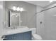 Well-lit bathroom featuring a modern vanity with a marble countertop and a walk-in shower with white marble tiling at 8522 E Montebello Ave, Scottsdale, AZ 85250