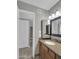 Bathroom with a light wood vanity, stone countertops, and neutral walls at 8522 E Montebello Ave, Scottsdale, AZ 85250