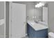 Bright bathroom with a stylish blue vanity with marble countertop, offering a clean and modern aesthetic at 8522 E Montebello Ave, Scottsdale, AZ 85250