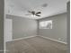 Spacious bedroom with neutral carpet, ceiling fan, and window, offering a serene and comfortable living space at 8522 E Montebello Ave, Scottsdale, AZ 85250
