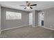 Spacious bedroom with carpet flooring, large window and a ceiling fan at 8522 E Montebello Ave, Scottsdale, AZ 85250