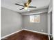 Cozy bedroom with hardwood floors, a ceiling fan, and natural light from the window, creating a comfortable atmosphere at 8522 E Montebello Ave, Scottsdale, AZ 85250