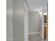 Hallway with bi-fold closet doors and an entrance to a bathroom; neutral wall color throughout at 8522 E Montebello Ave, Scottsdale, AZ 85250