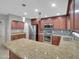 Modern kitchen boasting stainless steel appliances and a granite island at 8522 E Montebello Ave, Scottsdale, AZ 85250