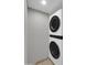 A modern, stacked washer and dryer unit in a laundry area at 8522 E Montebello Ave, Scottsdale, AZ 85250