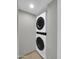 A modern, stacked washer and dryer unit in a laundry area at 8522 E Montebello Ave, Scottsdale, AZ 85250