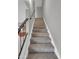 Carpeted staircase leading to the upper level with wood railing at 8522 E Montebello Ave, Scottsdale, AZ 85250