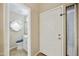 An entryway with a half bath featuring tiled floor and a decorative mirror at 8614 N 67Th Dr, Peoria, AZ 85345