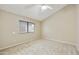 Bedroom featuring plush carpet, neutral colors, vaulted ceilings, and a window at 8614 N 67Th Dr, Peoria, AZ 85345
