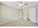 Neutral bedroom featuring a ceiling fan and standard closet with white doors at 8614 N 67Th Dr, Peoria, AZ 85345