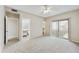 Bedroom featuring plush carpet, neutral colors, and sliding glass doors leading to an outdoor area at 8614 N 67Th Dr, Peoria, AZ 85345