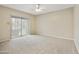 Spacious bedroom featuring neutral carpet, an exit to the balcony, and neutral walls at 8614 N 67Th Dr, Peoria, AZ 85345