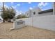 View of the 'Fountain Shadow' community entrance sign, set against a stucco wall and desert landscaping at 8614 N 67Th Dr, Peoria, AZ 85345