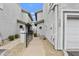 A walkway between townhouses showcasing stucco walls and desert-style landscaping at 8614 N 67Th Dr, Peoria, AZ 85345