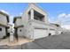 View of the exterior elevation of a two-story townhouse with an attached garage and a balcony with metal railing at 8614 N 67Th Dr, Peoria, AZ 85345