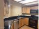 Cozy kitchen with sleek black countertops and stainless steel appliances at 8614 N 67Th Dr, Peoria, AZ 85345