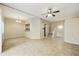 Open living room with tile flooring, ceiling fan, and staircase to the upper level at 8614 N 67Th Dr, Peoria, AZ 85345