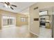 Bright living room with tile flooring, ceiling fan, and sliding door access to the outside at 8614 N 67Th Dr, Peoria, AZ 85345