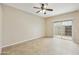 A well-lit living room featuring tile floors and a sliding glass door to the backyard at 8614 N 67Th Dr, Peoria, AZ 85345