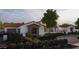 Charming stucco house showcases detailed wooden window features, complemented by colorful landscaping at Xxx N 158Th Ave, Surprise, AZ 85387