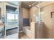 Modern bathroom featuring tile shower, soaking tub, and view into the bedroom at 1 E Lexington Ave # 503, Phoenix, AZ 85012