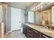 Modern bathroom with double vanity, granite countertops, and glass-enclosed shower at 1 E Lexington Ave # 503, Phoenix, AZ 85012