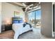 Comfortable bedroom featuring a large window with city views and modern decor at 1 E Lexington Ave # 503, Phoenix, AZ 85012