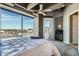 Bright bedroom with a large window, ceiling fan, and access to a balcony at 1 E Lexington Ave # 503, Phoenix, AZ 85012