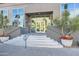 Welcoming building entrance with steps, potted flowers, and glass doors reflecting palm trees at 1 E Lexington Ave # 503, Phoenix, AZ 85012