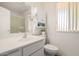 Bright bathroom featuring white vanity, shower with glass door, and functional decor at 10439 W Saratoga Cir, Sun City, AZ 85351