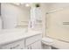 Bright bathroom featuring white vanity, shower with glass door, and functional decor at 10439 W Saratoga Cir, Sun City, AZ 85351