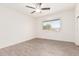 Bright bedroom featuring wood-look floors, ceiling fan, and a window at 10439 W Saratoga Cir, Sun City, AZ 85351