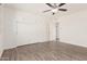 Bedroom featuring built-in cabinets, a ceiling fan, and wood-look floors at 10439 W Saratoga Cir, Sun City, AZ 85351