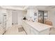 Bright kitchen featuring white cabinets and a sliding glass door to the exterior at 10439 W Saratoga Cir, Sun City, AZ 85351