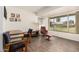 Bright and airy living space with wood-look floors, desk, and cozy seating area at 10439 W Saratoga Cir, Sun City, AZ 85351