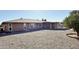 View of the back of house with a sunroom and a gravel yard with citrus tree at 10450 W Sutters Gold Ln, Sun City, AZ 85351